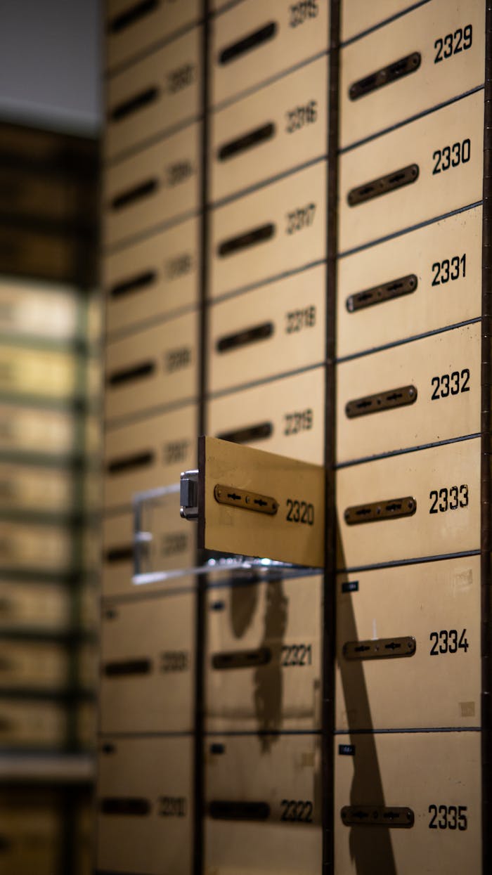 team-06 Vertical shot of metallic lockboxes with numbers in a bank vault.