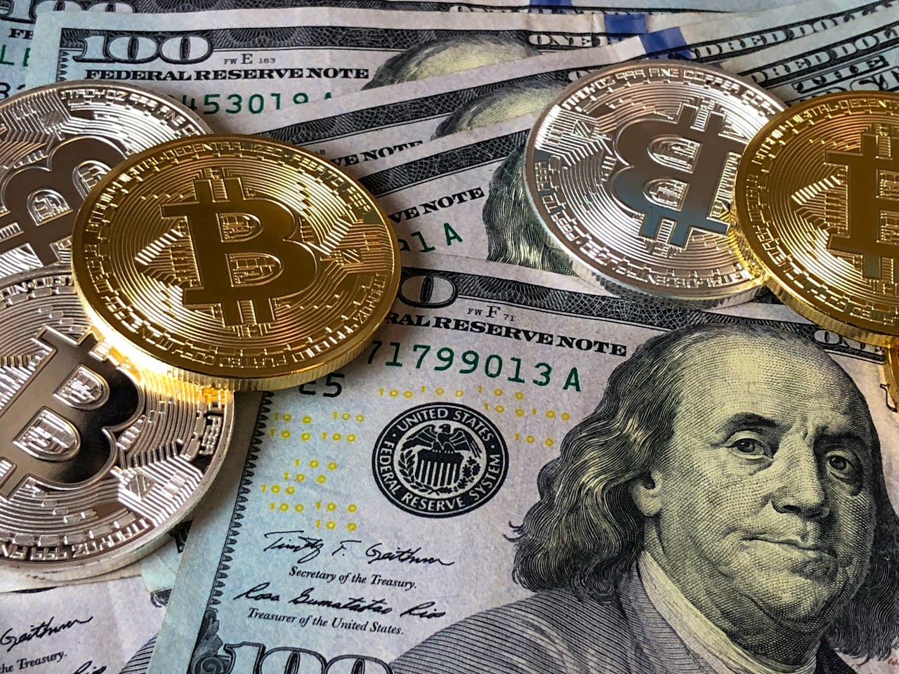 services-bg A close-up photo depicting Bitcoin coins on top of US dollar bills, symbolizing finance and cryptocurrency.